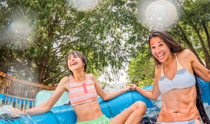 Two people on a water tube slide