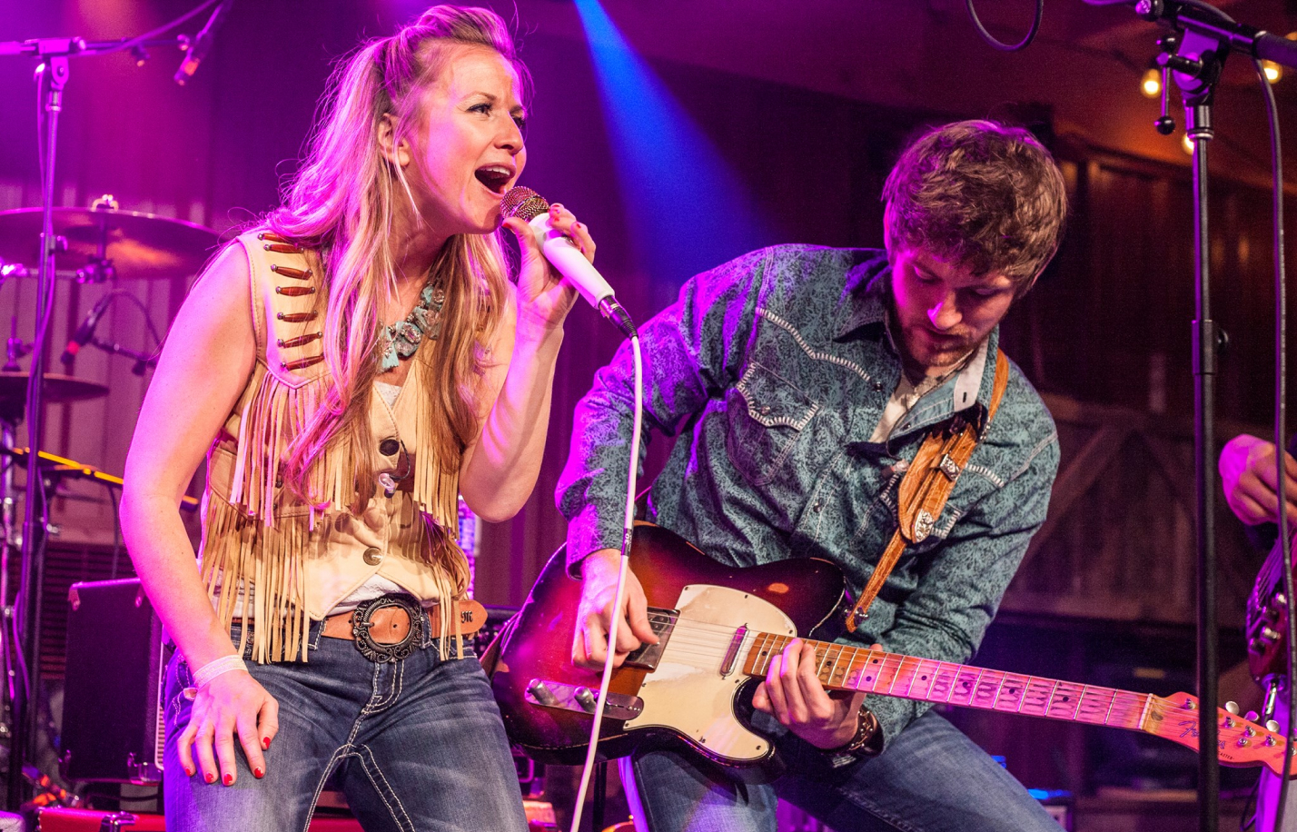 Martin and Kelly playing guitar on stage