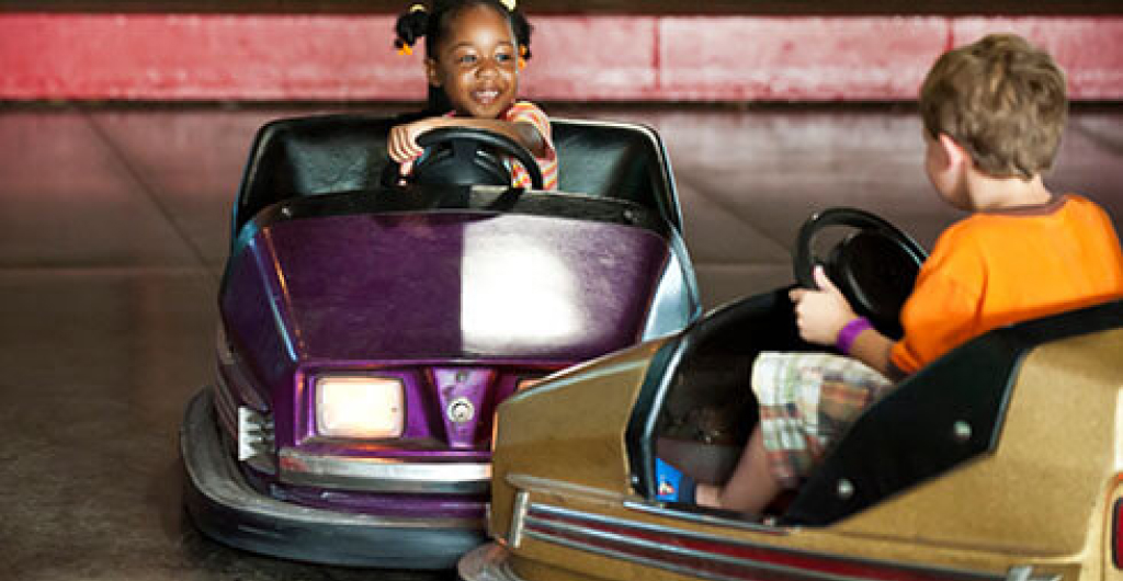 Two children riding bumper cars