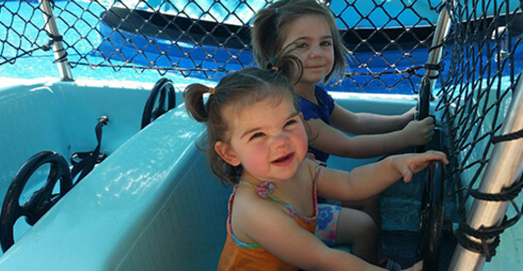 Two children on a small boat ride