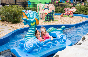 Two children on a kid friendly water flume ride
