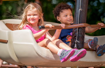 Two children riding The Little Gliders at Busch Gardens Williamsburg