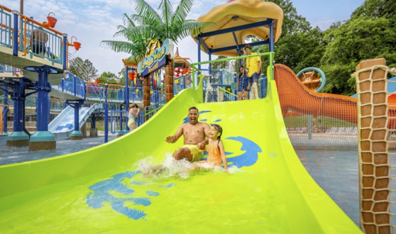 Man and child on a children's water feature