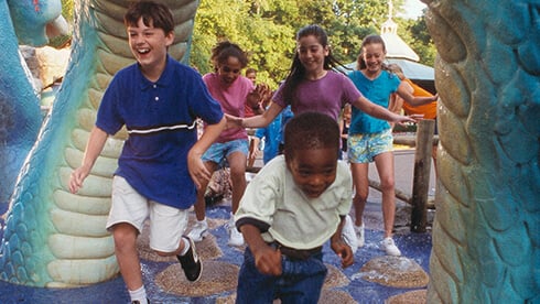 Land of the Dragons includes kids rides, tree house, climbing ropes, slides, and a water play area.